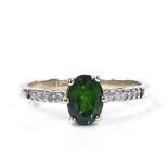 A 9ct gold green garnet solitaire ring, with diamond set shoulders and bridge, setting height 7.1mm,