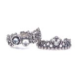PANDORA - a sterling silver princess tiara ring, size S, and a floral stone set eternity ring,