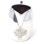 A George VI silver cream jug, of barrel form with engraved floral emblem, by A L Davenport Ltd,