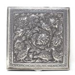 A Persian silver square box, with relief embossed bird and flower hinged lid, and floral engraved