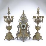 An ornate 19th century cast brass-cased clock garniture, enamel dial signed Richond of Montmartre,