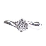 An 18ct white gold diamond cluster ring, setting height 5.6mm, size I, 2.5g