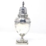 An Edwardian silver sugar caster, with flame finial, pierced lid and ribbed body, by Goldsmiths &