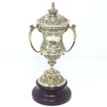 A small silver-gilt lidded 2-handled trophy, on turned wood stand, by Mappin & Webb, hallmarks