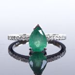 A 14ct white gold solitaire emerald ring, with diamond set shoulders, pair-cut emerald approx 1.