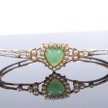 A Victorian 15ct gold green stone and pearl heart-shaped hinged bangle, with openwork body, internal