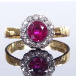 A 22ct gold ruby and diamond cluster flowerhead ring, ruby approx 1ct, setting height 10.7mm, size