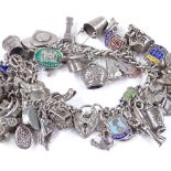A silver heart-lock curb link charm bracelet, set with silver charms, 101.3g