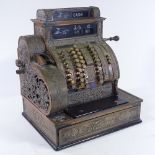 An Antique National cash register in ornate relief cast-brass case, width 47cm, height 54cm