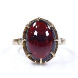An unmarked gold oval cabochon garnet ring, setting height 15.4mm, size N, 4g