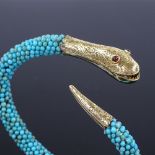 A Victorian turquoise and garnet snake bangle, with unmarked 15ct gold head and tail mounts, with
