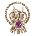 CARTIER - a 9ct gold cabochon ruby and diamond cluster rope twist knot dress clip/brooch, signed