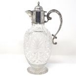 An Edwardian silver-mounted cut-glass claret jug, with scrolled acanthus leaf handle and bright-