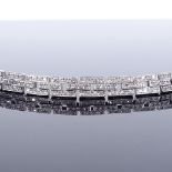 An Art Deco style 18ct white gold diamond line panel bracelet, of geometric form, total diamond