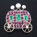 An unmarked yellow metal gem-set carriage brooch, set with diamond wheels, 3 cultured pearls and red