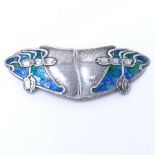 An Edwardian silver and peacock enamel belt buckle, of lobed form with planished finish, by