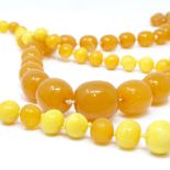 2 strings of graduated amber beads, largest orange bead length 20.7mm, orange necklace length