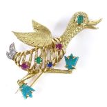 A French 1960s 18ct gold gem set running duck brooch, set with diamond, emerald, sapphire, ruby