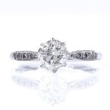 An 18ct white gold 0.78ct solitaire diamond ring, with platinum-topped diamond set shoulders,