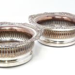 A pair of Antique silver plate on copper wine coaster, with gadrooned rims and oak bases, overall