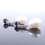 A pair of unmarked white gold pearl and diamond drop earrings, with stud fittings, earring height