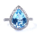 A 14ct white gold blue topaz and diamond cluster ring, with openwork bridge and diamond set