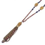 An Oriental string of carved polished vegetable ivory and stained wood bead sautoir necklace, with