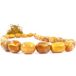 A string of polished graduated butterscotch amber prayer beads, largest bead length 19.8mm, necklace