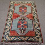 A Turkish red ground Sultanhan wool rug, with cream geometric border, 191cm x 120cm