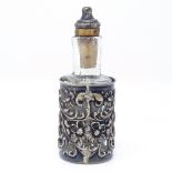 A small Edwardian silver-mounted glass toilet jar, with relief embossed and pierced floral