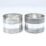 A pair of George V silver cylindrical napkin rings, with engine turned decoration, by E J