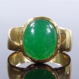 An unmarked gold cabochon green stone ring, setting height 15.5mm, size X, 10.5g