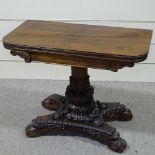 A William IV rosewood fold over card table, on elaborate carved acanthus decorated base