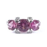 An unmarked white gold pink tourmaline and diamond dress ring, with diamond set shoulders,