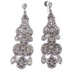 A pair of Edwardian unmarked silver and paste chandelier drop earrings, with closed-back settings,