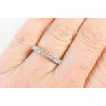 Diamond half eternity ring, set with nine brilliant cut diamonds in 18ct gold white claw mounts on a