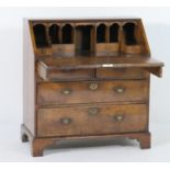 George I walnut bureau, circa 1715-25, crossbanded and feather banded throughout, having a fitted