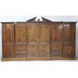 Late George III mahogany breakfront press wardrobe, circa 1800, the central press with a broken