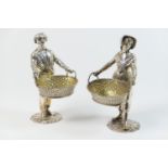 Pair of silver figural table salts, maker E Bd, London 1979, finely worked as peasant fruit pickers,