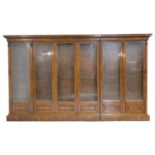 Victorian burr walnut library bookcase, circa 1860, carved moulded cornice over three pairs of