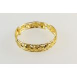 Eastern made 22ct gold hinged bangle, chased and pierced with phoenix and dragons, screw catch,