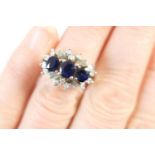 Sapphire and diamond cluster ring, three oval cut sapphires well matched in colour and totalling