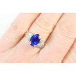 Tanzanite and diamond cluster ring, the oval cut tanzanite of approx. 2.91cts, flanked by two