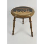 Italian walnut and marquetry stool, circular seat inlaid with dancing figures beneath a vine arbour,