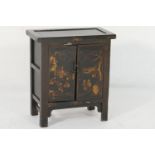 Chinese black lacquered cabinet, late 19th Century, with two cupboard doors with an iron latch and