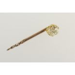 Diamond stick pin, old brilliant cut stone of approx. 0.25ct, in a yellow metal claw mount and