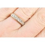 Diamond half eternity ring, channel set with seven princess cut diamonds, totalling approx. 0.