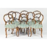 Set of eight Victorian walnut balloon back dining chairs, circa 1850, with a carved and pierced