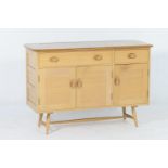 Ercol elm and beech sideboard, matching the previous lot, fitted with one long and one short