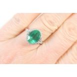 Lorique emerald and diamond cluster ring, central oval cut emerald of approx. 2cts (10mm x 8mm),